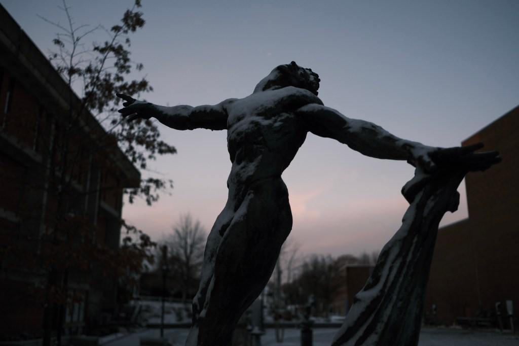 A photo of a bronze sculpture of Mikhail Baryshnikov by Greg Wyatt, which stands in the Wyatt Sculpture Garden at Bridgewater State University.